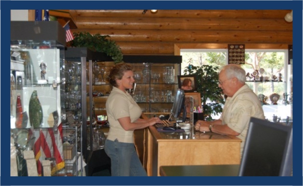 Kami, from Arnolds for Awards in Shingle Springs, California assists a customers at the counter using BizWizard Order Manager™